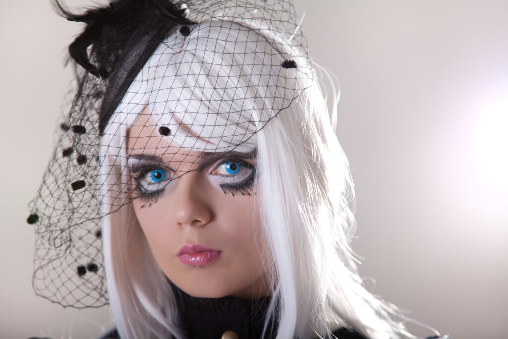 Portrait of young woman wearing blue contact lenses, studio shot